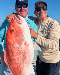 A pair of anglers with a big 22-inch catch in North Bay Village