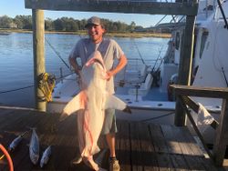 A lone fisherman in Calabash, holding a 29-inch catch