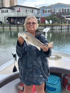 Angler holding a redfish in Calabash