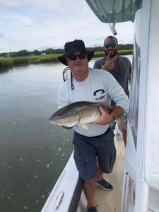 An image of two people fishing in Calabash