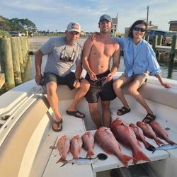 Three people fishing in the beautiful waters of Gulf Shores