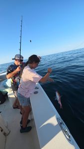 Fresh caught fish being reeled in on fishing boat in Gulf Shores AL