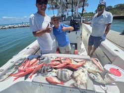 Successful fishing trip in Gulf Shores AL with fresh catch displayed on boat deck