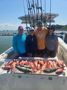 Fishing charter boat displaying large catch of red snapper fish in Gulf Shores Alabama