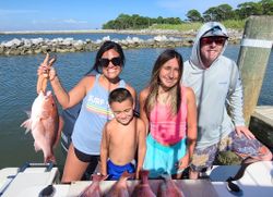 Red snapper fishing success in Gulf Shores Alabama with fresh catch displayed on boat