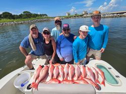 Successful red snapper fishing trip in Gulf Shores AL with large catch displayed on boat