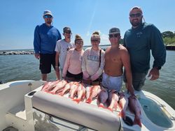 Successful red snapper fishing trip in Gulf Shores AL with large catch displayed on boat