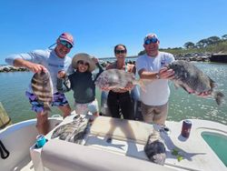 Successful sheepshead fishing trip in Gulf Shores AL with fresh catch displayed on boat