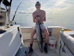 Fisherman holding a king mackerel in Gulf Shores