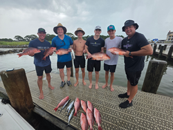Reeling in Red Snappers on a partly cloudy day in Gulf Shores!