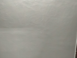 White painted ceiling and wall corner in interior space