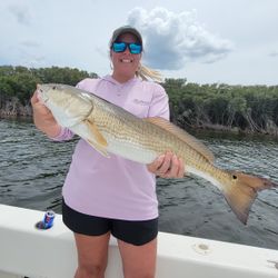 Angler proudly holding a large redfish in Florida