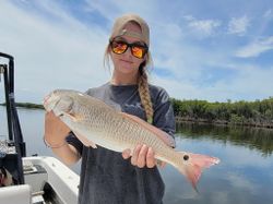 A person fishing for a redfish in Florida