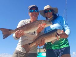 Two redfish, 25 inches long, caught while fishing in FL.