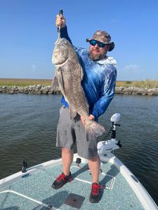 Angler with a large black drum catch from Hopedale