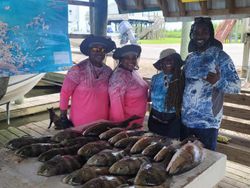 Four people enjoying a fishing tour in Hopedale