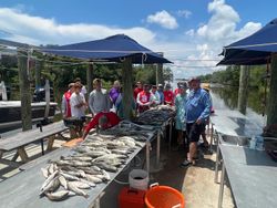 Group of 12 people enjoying fishing tours in Hopedale