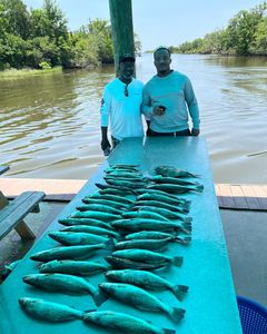 Two people enjoying a fishing tour in Hopedale