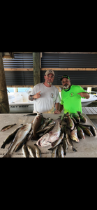 Two anglers with two fish caught in LA