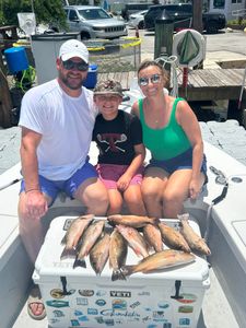 3 people fishing on the shore in FL