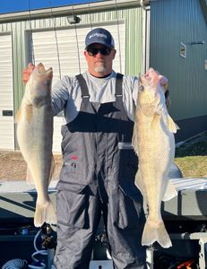 Angler holding two walleye fish in OH