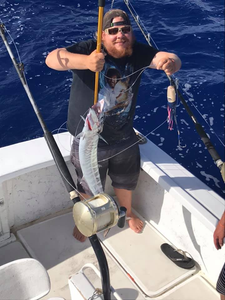 A single fisherman in Hawaii catching a fish