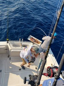 Deep sea fishing scene with large fish being brought aboard fishing boat in Fort Walton Beach FL waters