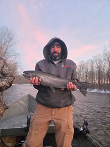Fisherman holding a 24-inch fish in Altmar