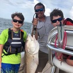 A group of 3 people fishing on a sunny day in Port Orange