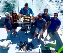 A group of 6 people enjoying a fishing trip in NY