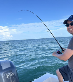 Lone fisherman in Florida reeling in a fish