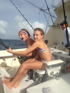 Three people enjoying a fishing trip in Palm Beach