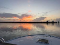 Fishing boat bow on calm water during sunset in Palm Beach Florida