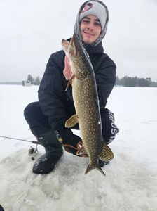 A person fishing for a chain pickerel in ON