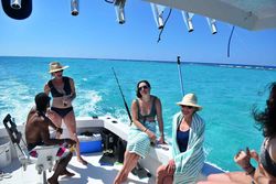 Three people enjoying a fishing trip in the Cayman Islands