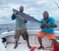 Two people fishing with one big fish in Cayman Islands