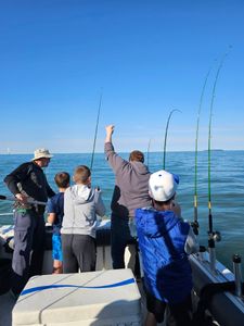 Fishing boat on Lake Erie near Port Clinton OH with multiple fishing rods and excited anglers