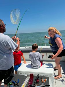 Fishing trip on boat in Port Clinton OH with net and fishing equipment ready