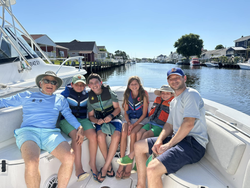 Group of 6 people enjoying fishing trip in Lacey Township