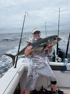 A fisherman holding a blackfin tuna in Point Pleasant