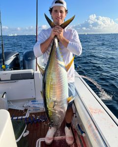 Angler holding a large king mackerel fish caught in Point Pleasant