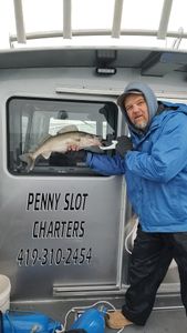 A fisherman holding a 16-inch walleye in OH
