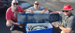 Three people enjoying a fishing trip at the lakeside in Marblehead