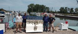 Four friends enjoying a lakeside fishing trip at Lakeside Marblehead