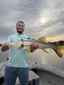 Evening snook catch on calm water.