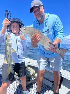 Two anglers fishing for Snook and Atlantic Croaker in FL