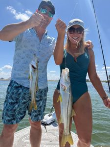Two snook caught while fishing in Riverview FL displayed on boat deck