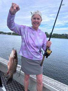 Fisherman holding a grey snapper in Riverview