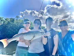 Angler holding a large redfish caught in Riverview