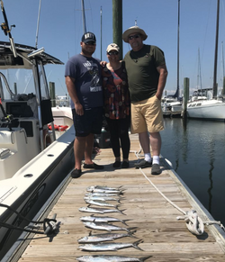 Three people enjoying a fishing cruise at Wrightsville Beach